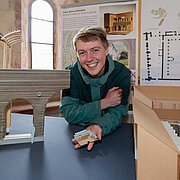 Stefan Simon with his design for the title Lehm, Steine, Schindeln. 