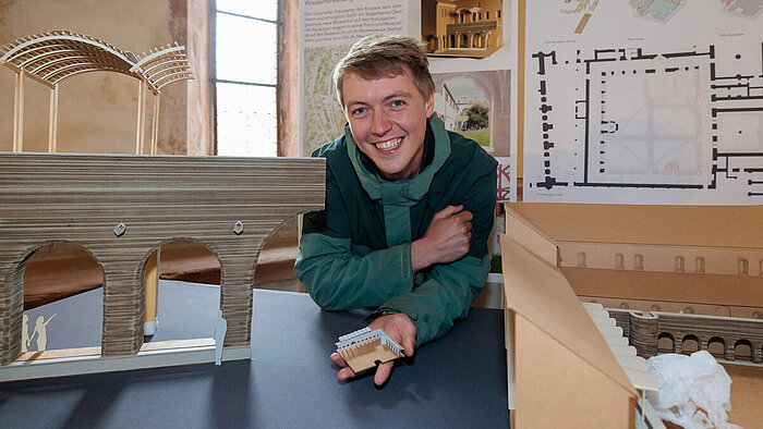 Stefan Simon with his design for the title Lehm, Steine, Schindeln. 
