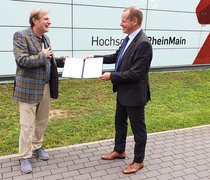 Prof. Dr. Gerhard Trabert (li.) erhält die Urkunde als Hochschullehrer des Jahres 2020 aus den Händen von Prof. Dr. Bernhard Kempen, Präsident des DHV