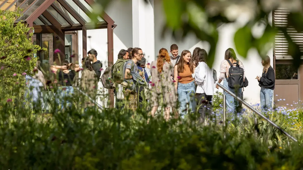 Eine Gruppe Studierender vor einem Gebäude