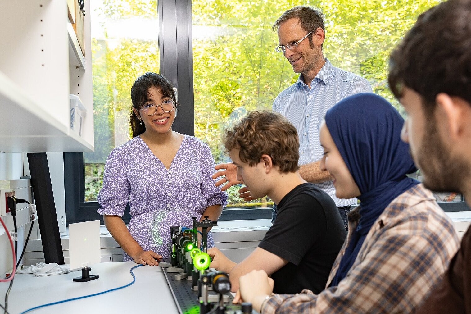 Studierende stehen an einer Werkbank