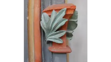 Ornamentation made from stylised leaves. The colours range from a soft green to a warm orange.