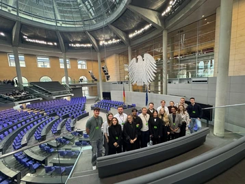 Students from the Master's program in Real Estate in the visitors' gallery of the plenary chamber of the German Bundestag. The chairs of the members of parliament can be seen in the background of the group photo.