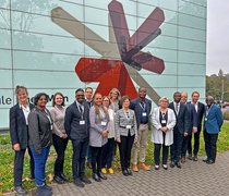 Vertreter:innen der Namibia University of Science and Technology und der Hochschule RheinMain stehen für ein Gruppenfoto vor dem G-Gebäude der Hochschule RheinMain auf dem Campus Kurt-Schumacher-Ring in Wiesbaden