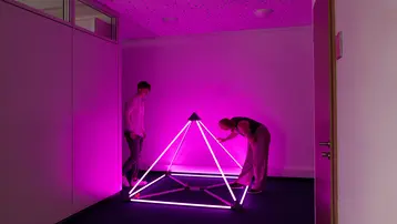 Studierenden inspizieren ein Lichtobjekt