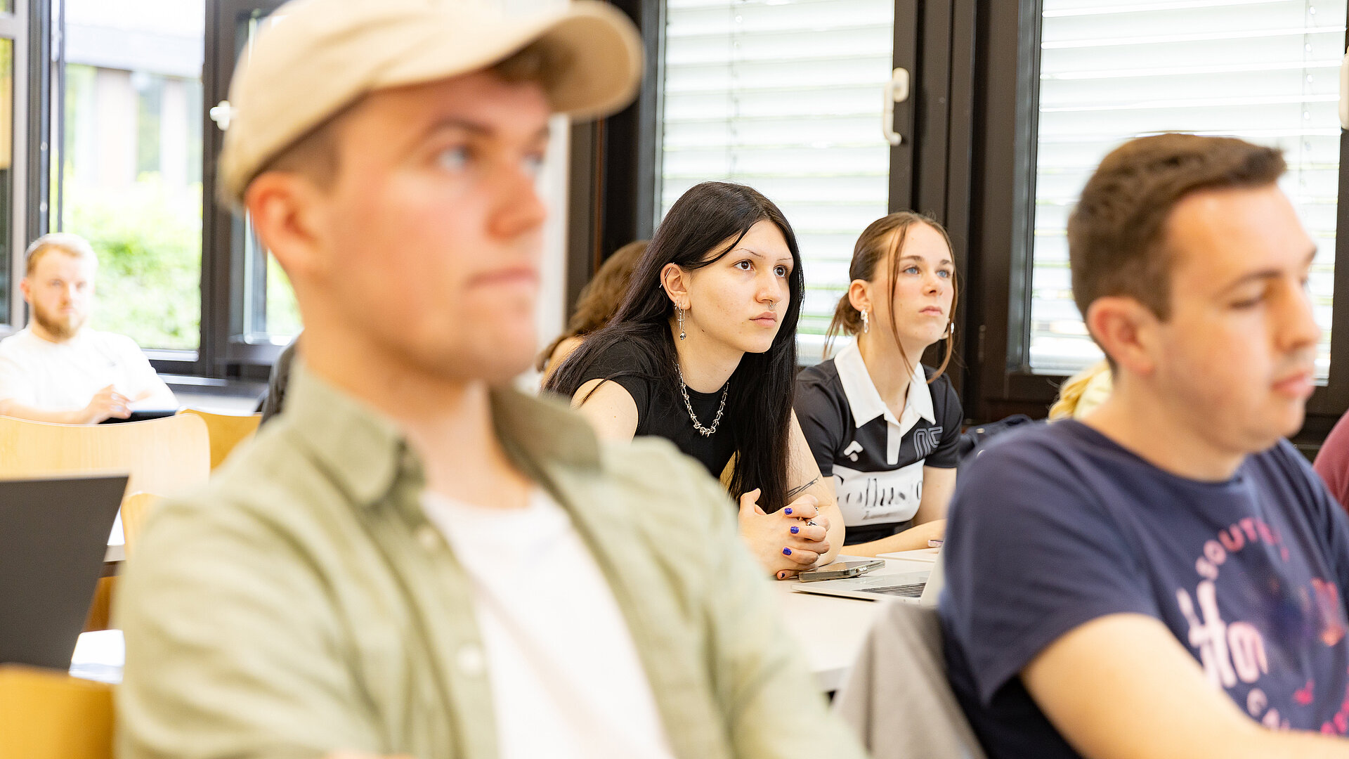 Mehrere Studierende sitzen in einem Hörsaal