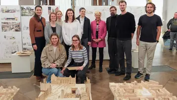 Böttiger Prize 2025 winners. Together with the jury, they stand among the plans and models of their designs.