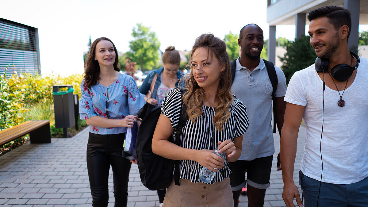 Fünf Studierende laufen über den Campus Rüsselsheim
