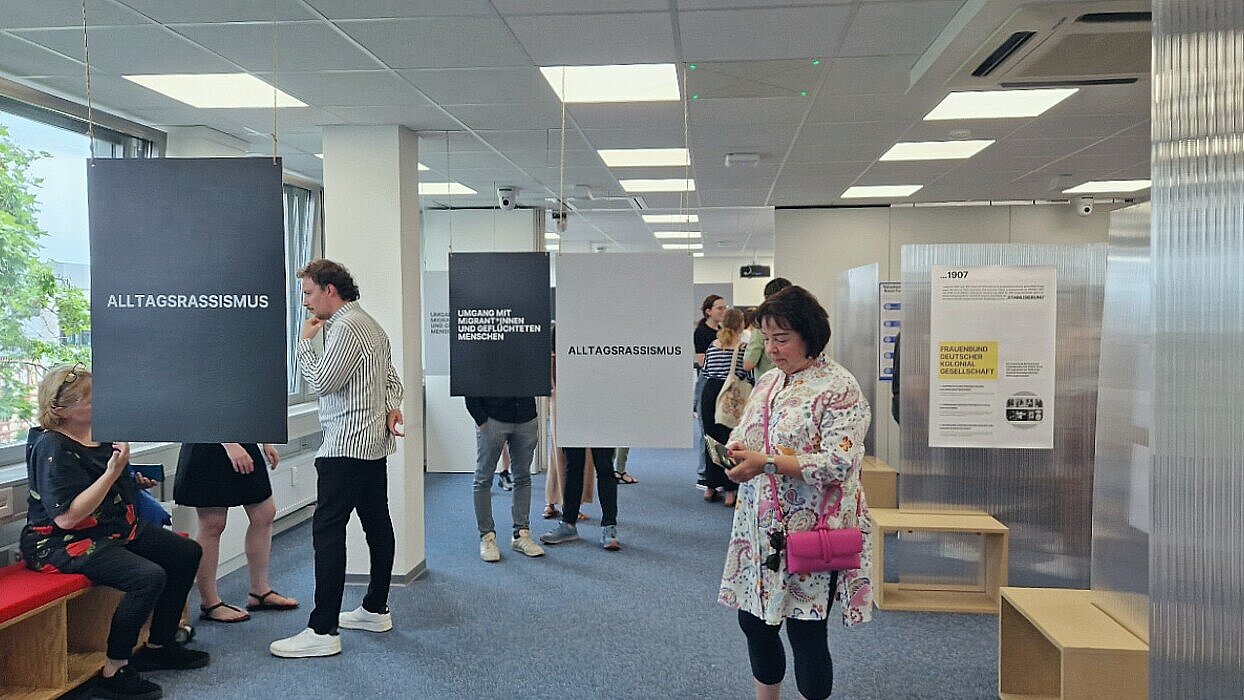Besucher:innen betrachten die Ausstellung im Methodenlabor des Fachbereichs Sozialwesen.