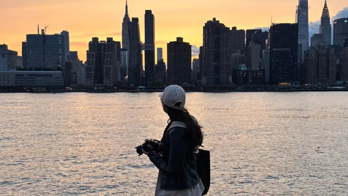 Sobia Khan vor der Skyline von New York während des Sonnenuntergangs