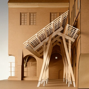 Architectural model made of wood and cardboard by Isabel Hiort on the theme of ‘A roof as a constant – restoration of the cloister’. It shows a roof structure in front of a historic building.