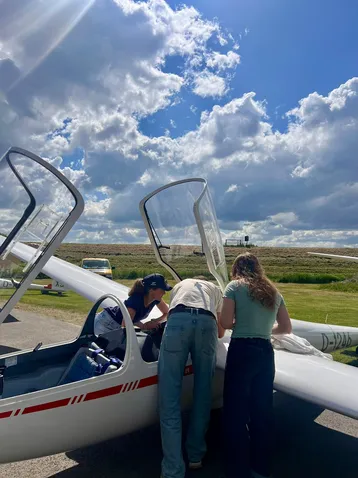 Vorbereitungen vor dem Flug: Die Studierenden bauen die Messapparatur in die ASK-21 ein.
